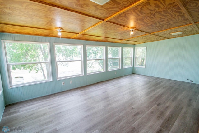 spare room featuring wood-type flooring and wood ceiling