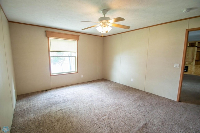 unfurnished bedroom featuring ceiling fan, carpet, ornamental molding, and a textured ceiling