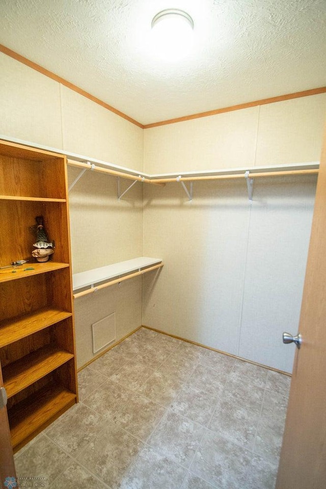 spacious closet with light tile patterned floors