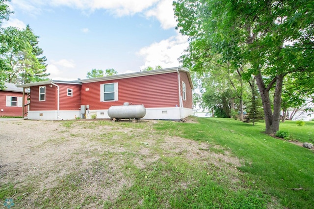 rear view of property featuring a lawn