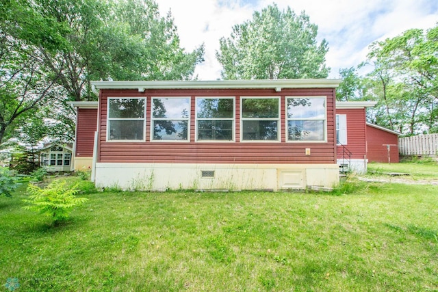 view of side of property with a lawn