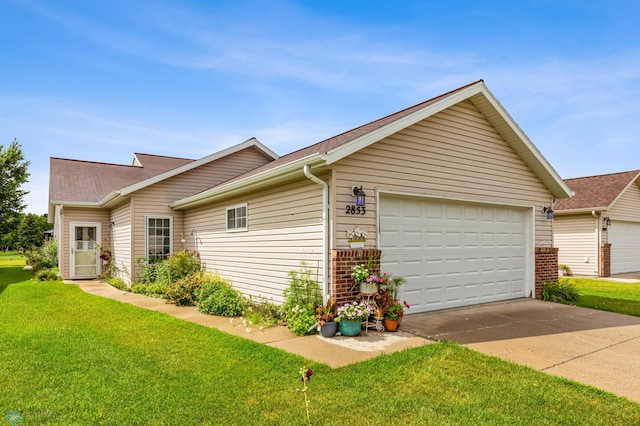 view of home's exterior featuring a garage and a lawn