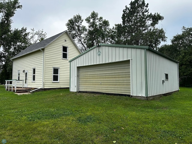 exterior space with a garage and a lawn