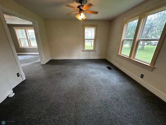 carpeted empty room featuring ceiling fan