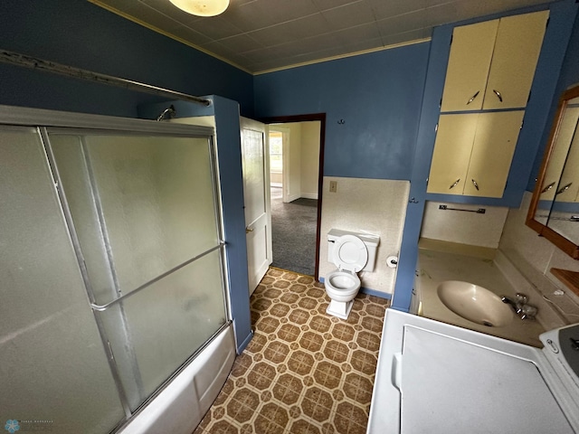 bathroom featuring tile patterned floors, vanity, and bath / shower combo with glass door