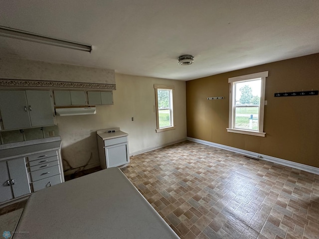 kitchen with a wealth of natural light and light tile patterned flooring