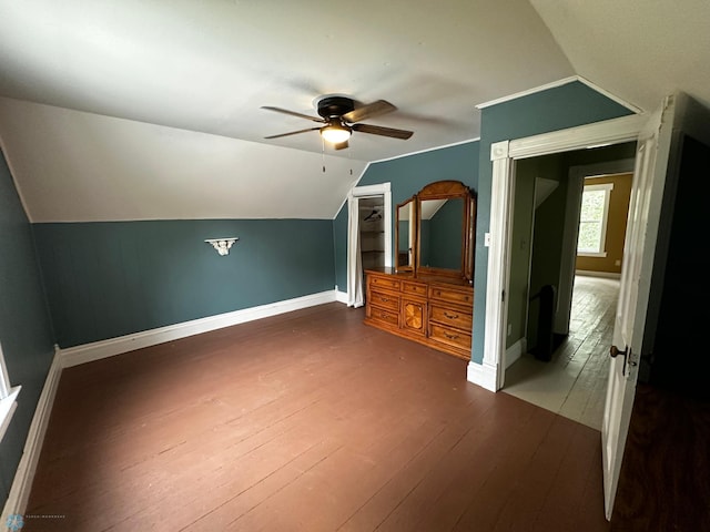 additional living space featuring hardwood / wood-style flooring, vaulted ceiling, and ceiling fan