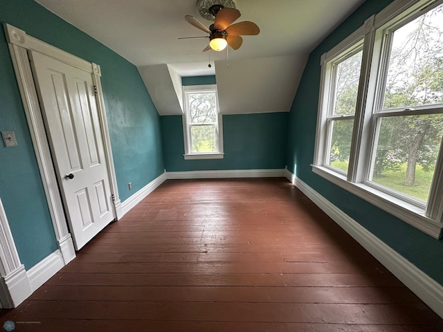 additional living space with a wealth of natural light, ceiling fan, and dark hardwood / wood-style flooring