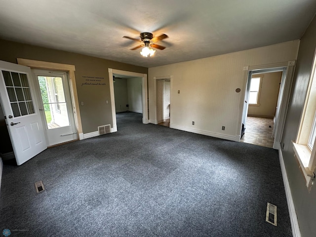 unfurnished bedroom featuring ceiling fan and dark colored carpet