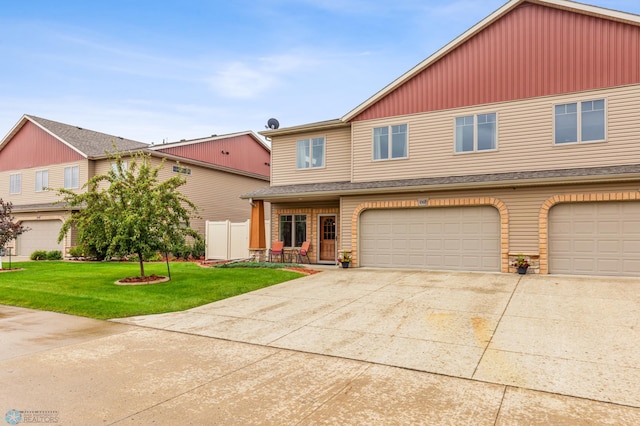 view of front of property with a front lawn and a garage