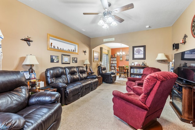 living room with carpet floors and ceiling fan with notable chandelier