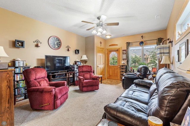 carpeted living room featuring ceiling fan