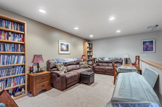 carpeted living room featuring a textured ceiling