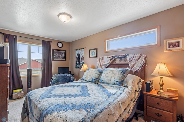 bedroom with carpet and a textured ceiling