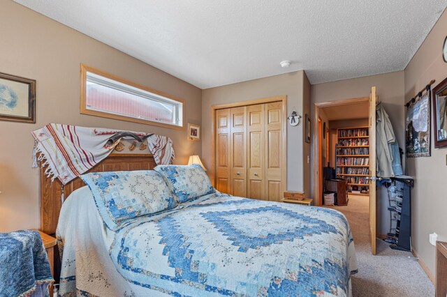 bedroom featuring a textured ceiling, a closet, and light carpet