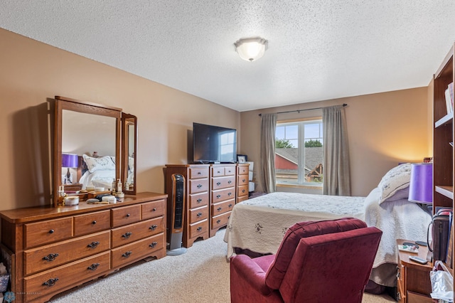 bedroom featuring a textured ceiling and carpet floors