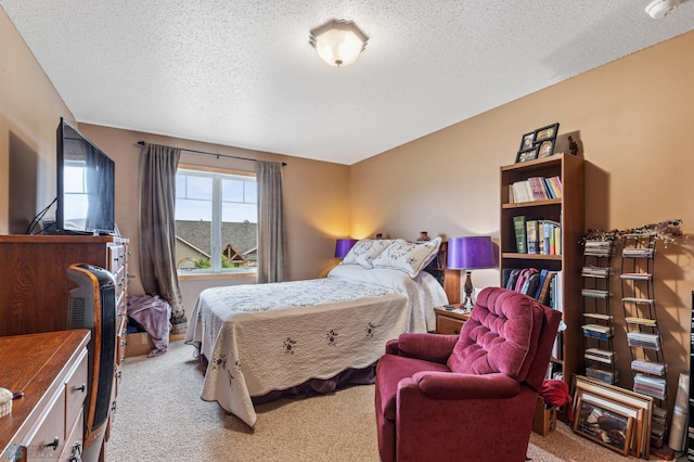 bedroom with a textured ceiling and carpet flooring