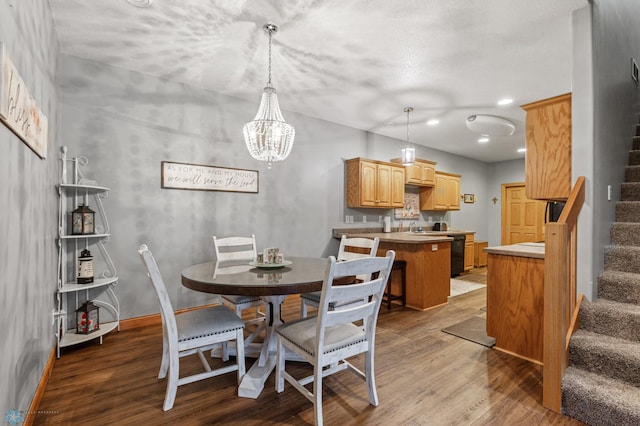 dining space with wood-type flooring and a notable chandelier