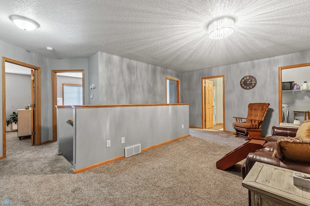 sitting room featuring carpet floors and a textured ceiling