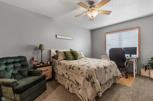 bedroom with a textured ceiling and dark carpet