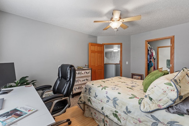 bedroom with a textured ceiling and ceiling fan