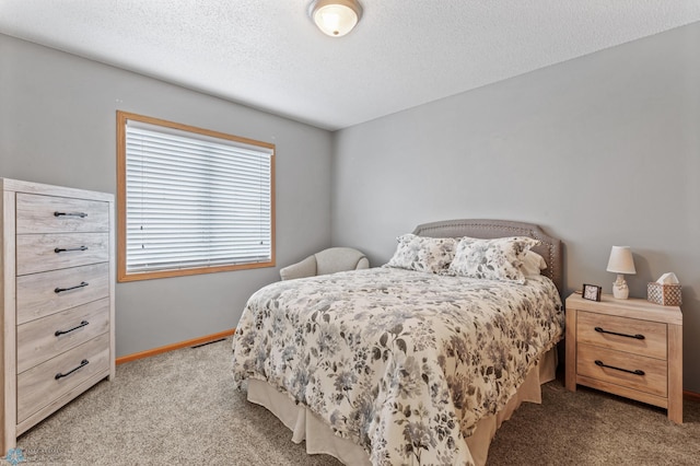 bedroom with light carpet and a textured ceiling