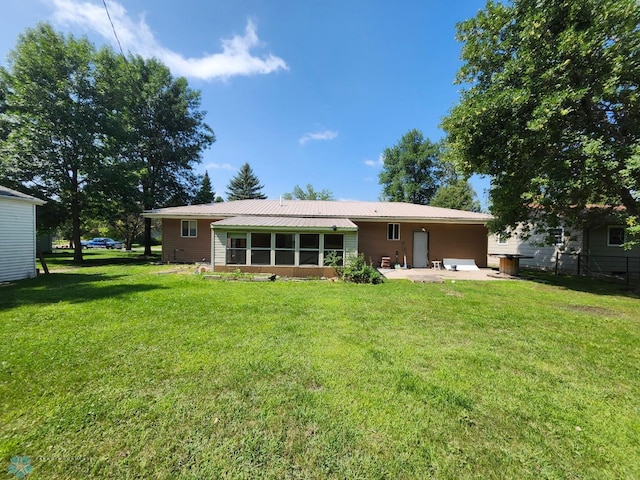 rear view of house with a patio area and a yard