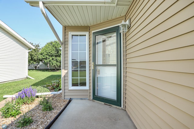 doorway to property featuring a yard