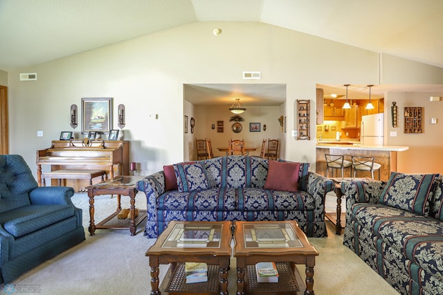 living room featuring lofted ceiling and light carpet