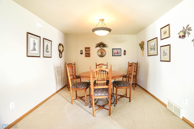 dining space with light colored carpet