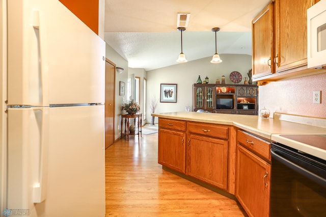 kitchen featuring light hardwood / wood-style flooring, pendant lighting, kitchen peninsula, white appliances, and vaulted ceiling