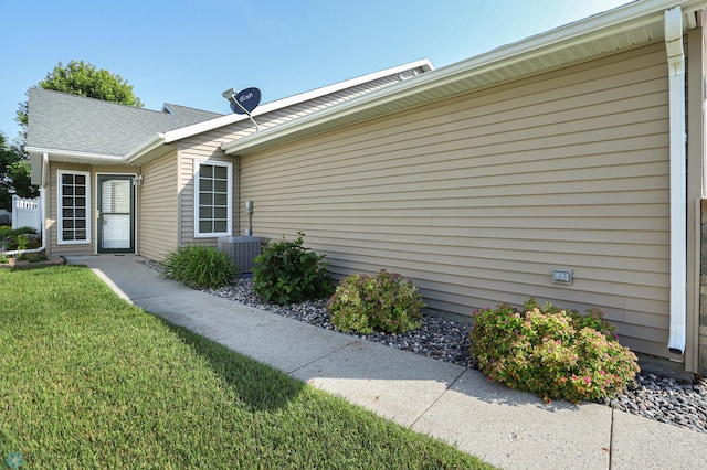 view of side of home featuring a lawn