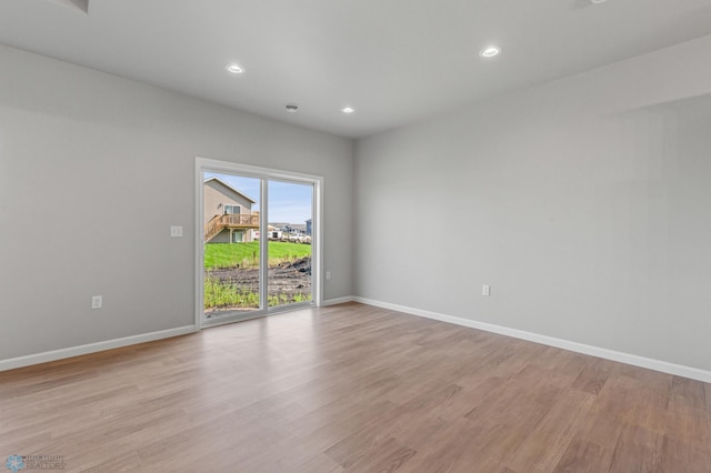 spare room featuring light wood-type flooring