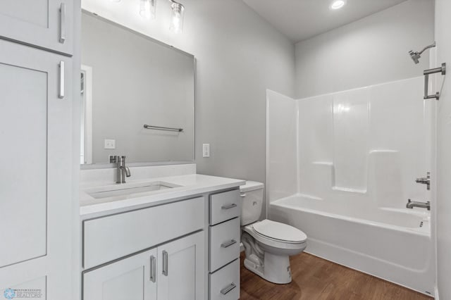 full bathroom featuring toilet, vanity, shower / bathing tub combination, and wood-type flooring