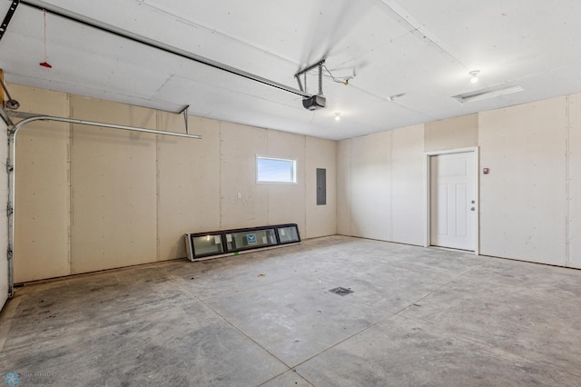 garage with a garage door opener and electric panel