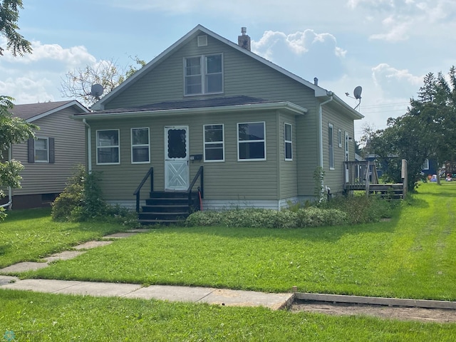 bungalow-style house with a front lawn