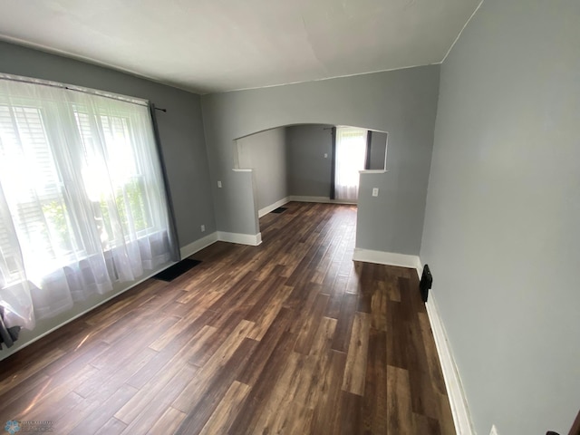 empty room with dark wood-type flooring