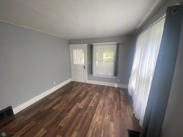 spare room with wood-type flooring