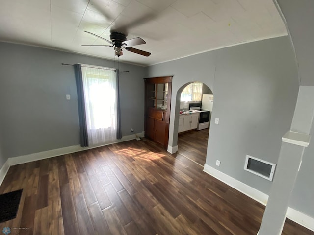 unfurnished bedroom featuring ceiling fan, crown molding, and wood-type flooring