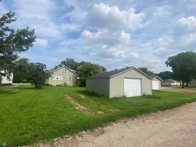 exterior space featuring an outbuilding, a yard, and a garage