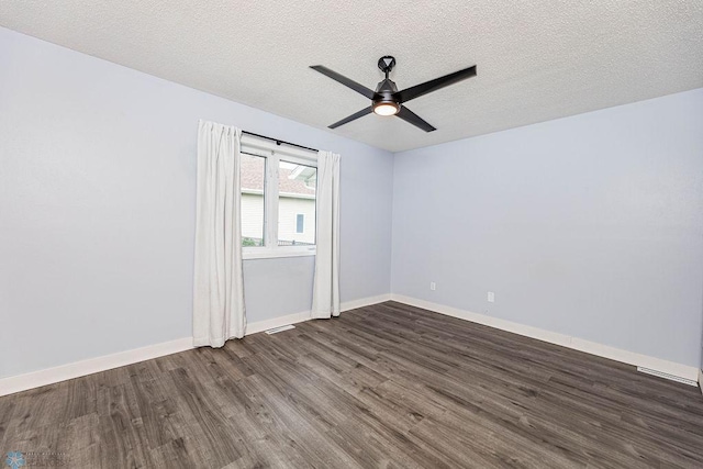 spare room with a textured ceiling, ceiling fan, and wood-type flooring