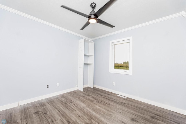 unfurnished bedroom with ceiling fan, ornamental molding, and wood-type flooring