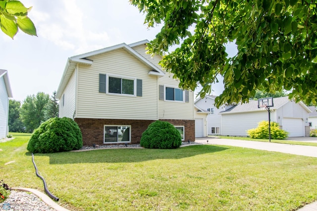 view of front of house with a garage and a front lawn