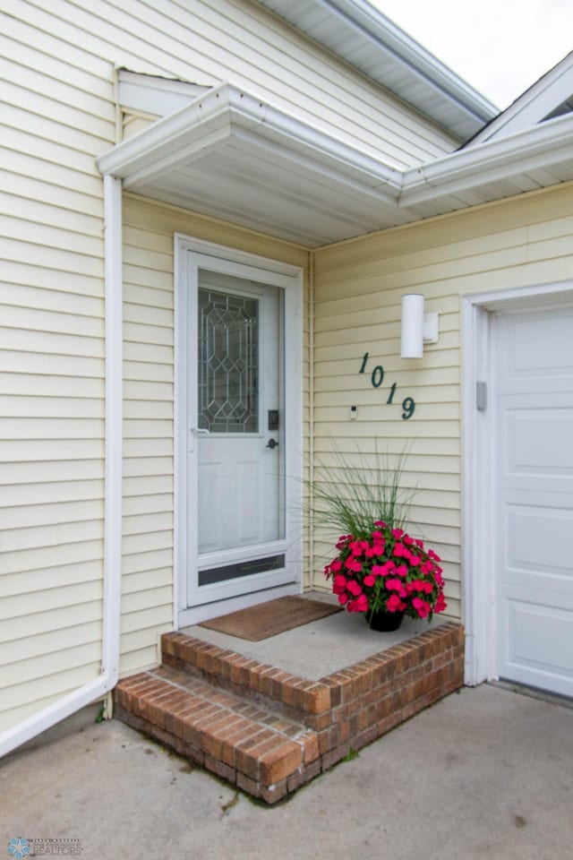 view of exterior entry with a garage