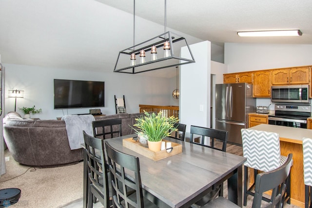 carpeted dining space featuring vaulted ceiling and a chandelier