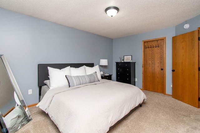 bedroom with carpet flooring and a textured ceiling