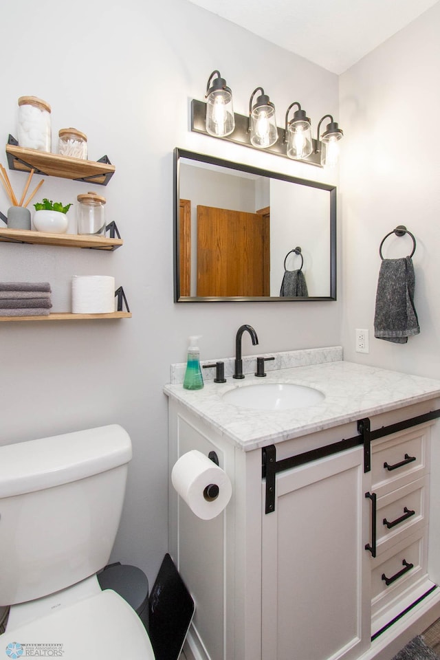 bathroom with toilet and vanity