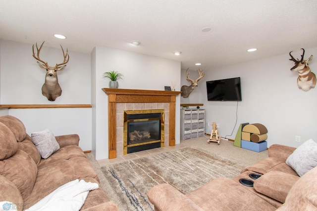 carpeted living room featuring a fireplace and a textured ceiling