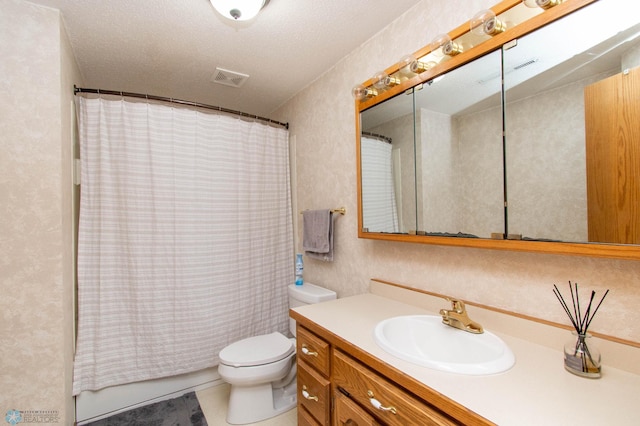 bathroom featuring a textured ceiling, toilet, and vanity