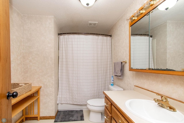 bathroom with a textured ceiling, toilet, vanity, and tile patterned floors